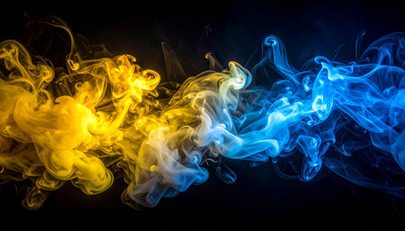 Colorful blue and yellow smoke of  black isolated background. Background from the smoke of vapeの素材