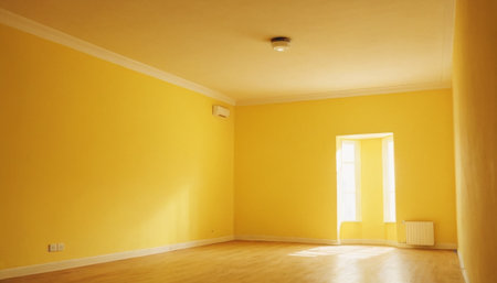 Interior of a room with yellow walls and white wooden floor.の素材