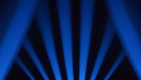 Blue rays of light on a dark background. Abstract blue background.の素材