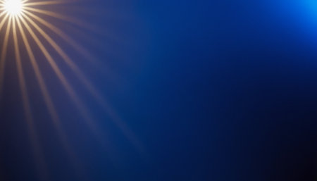sunlight on a dark blue background with lens flare and copy spaceの素材