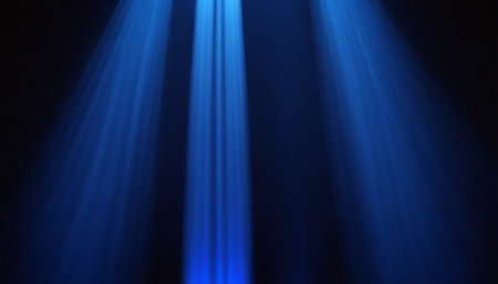 Blue rays of light in the dark. Abstract background for design.の素材