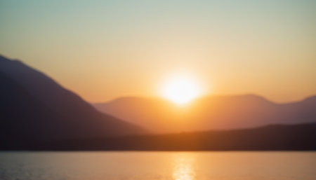 Blur nature background. Sunset over mountain lake. Defocused landscape.の素材