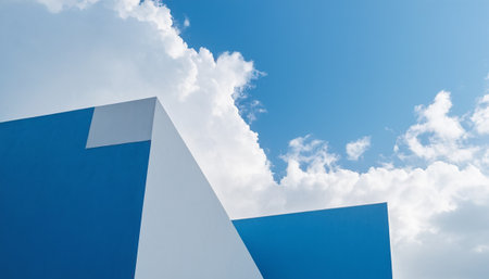 Blue building with blue sky and white clouds. Abstract architecture background.の素材