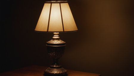 Vintage lamp on wooden table in dark room with copy space.の素材