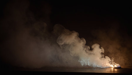 Flaming cloud of smoke on the sea at night. Selective focusの素材