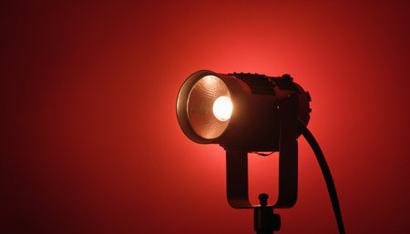 Studio lighting equipment on a red background. Studio lighting equipment. Soft focus.の素材