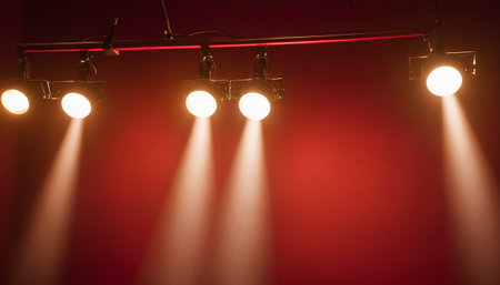 Stage lights on a red background. Lighting equipment with spotlights.の素材