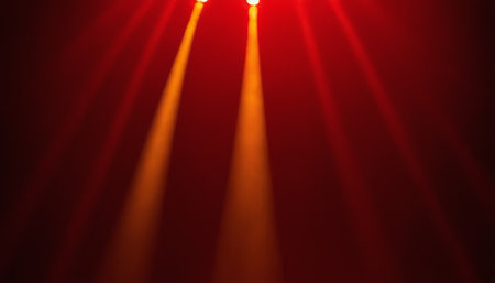 Colorful stage lights on a red background. Abstract blurred background.の素材