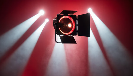 Cinema lighting equipment on red background. Light from spotlightsの素材