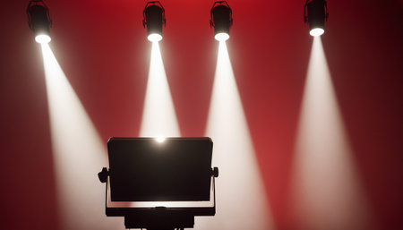 Stage lights against red background with vignette, 3d renderの素材