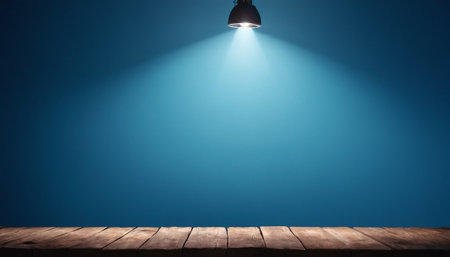 Empty wooden table and ceiling light on blue wall background. For product displayの素材