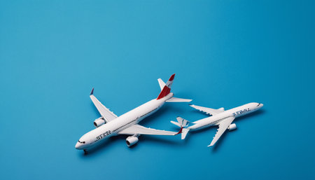 Airplane model on blue background. Travel concept. Top view.の素材