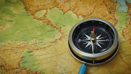 compass on the background of the map of the world and a magnifierの素材