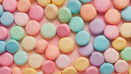 Colorful candies on pink background. Top view. Flat lay.の素材