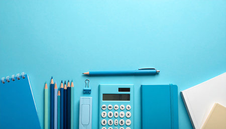 Office supplies on blue background. Back to school concept. Copy spaceの素材