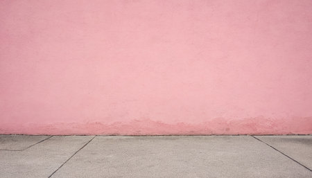 Pink wall with concrete floor and sidewalk. Abstract background for design.の素材