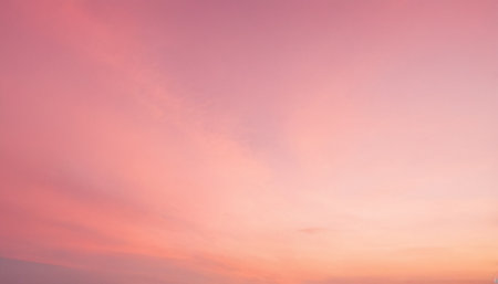 Sunset sky background with tiny clouds, soft pastel colors.の素材