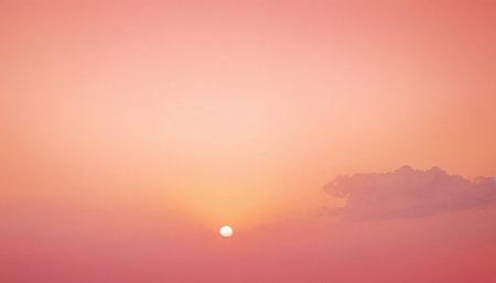 Sunset sky background with tiny clouds. Beautiful nature landscape with orange sky.の素材