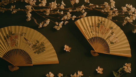 Japanese style fan and cherry blossoms on a dark green background.の素材