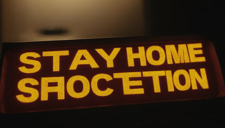 Stay at home sign on the wall in dark room. Coronavirus conceptの素材