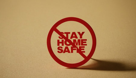 \Red \"\"Stay home stay safe\"\" sign on brown background\""の素材