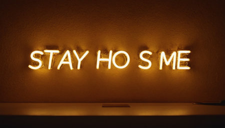 Stay at home sign in neon light on the wall. Quarantine conceptの素材