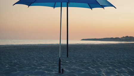 Umbrella on the beach at sunset. Vacation concept.の素材