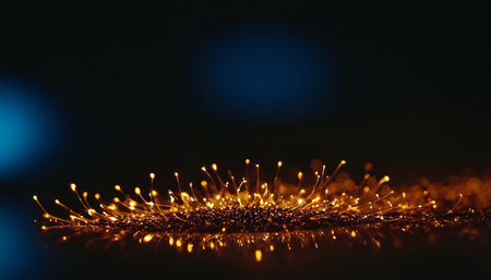 Golden Christmas lights on black background with copy space. Holiday concept.の素材