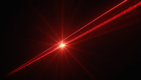 Abstract red light flare on black background. Rays of light from a laser.の素材