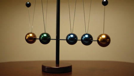 Close-up of Newton's cradle with balls in the foreground.の素材