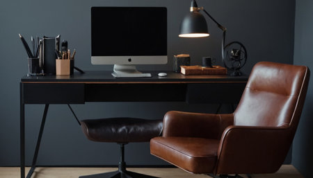Stylish workplace with computer, stationery and chair in dark roomの素材