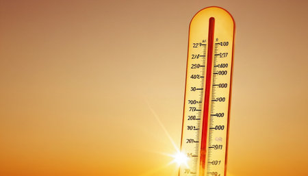 Thermometer on a background of the setting sun and the sunの素材