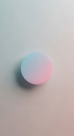 A smooth, pastel gradient circle with soft pink and blue hues casts a subtle shadow on a lightly textured, muted background.の写真素材