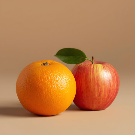 Still life composition of orange and apple under dramatic studio lightingの素材