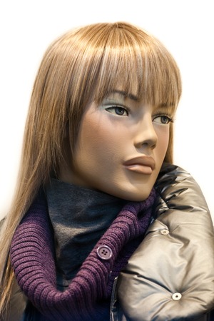 A close up of a mannequin with modern Italian style clothing in a shop windowの写真素材