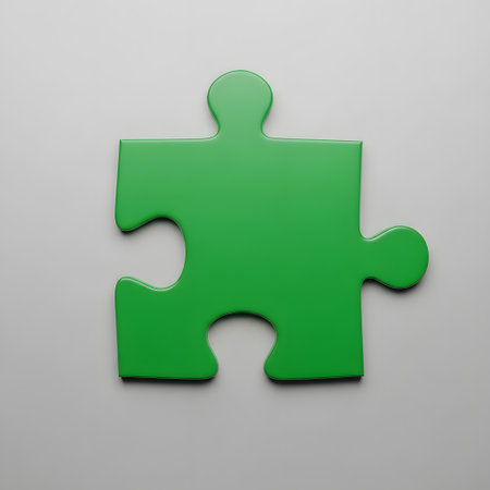 A solitary, bright green puzzle piece is centrally placed on a plain, light gray surface, casting a subtle shadow.の素材