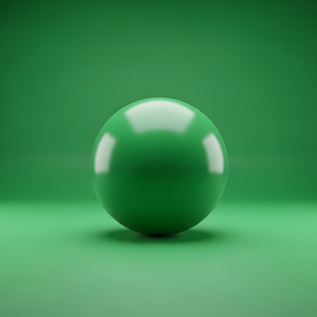 A perfectly round, glossy green sphere sits centered on a plain green surface, reflecting light.の素材