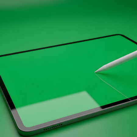 A modern digital tablet with a green screen is shown with a stylus pen touching the screen. The background is a solid green.の素材