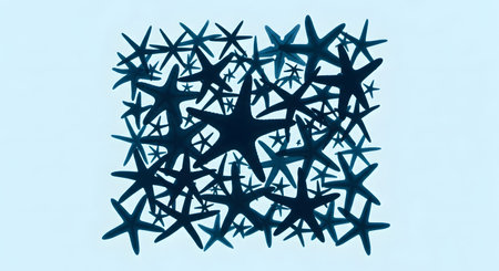A dense, abstract pattern of dark blue starfish silhouettes scattered across a pale blue background. The starfish vary in size and orientation.の素材