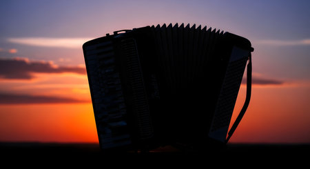A dark silhouette of a woven basket stands against a dramatic sunset with orange, pink, and purple hues in the sky.の素材