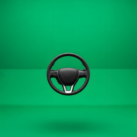 A sleek, modern car steering wheel is presented centrally against a solid, vibrant green backdrop with a subtle shadow.の素材