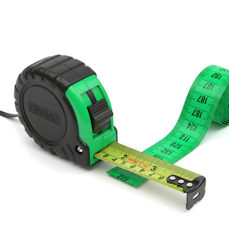 A close-up shot of a green and black retractable measuring tape, extended on a white surface, showing its markings.の素材