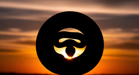 A striking silhouette of a human face is visible within a water droplet, set against a vibrant sunset sky.の素材