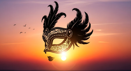 A detailed black masquerade mask with feather accents is silhouetted against a vibrant orange and purple sunset. Small birds fly in the distance.の素材