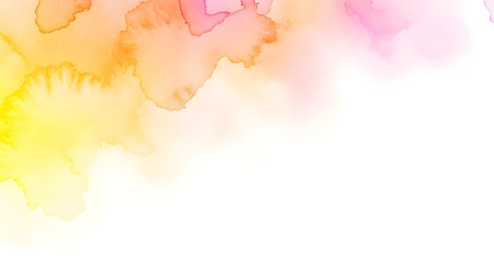 A delicate watercolor splash in warm yellow, orange, and pink tones on a white background.の素材