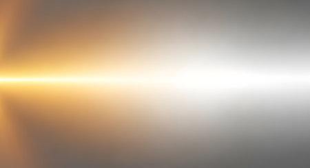 A luminous golden light beam cuts horizontally across a textured metallic surface, transitioning from warm tones to cool grays.の素材