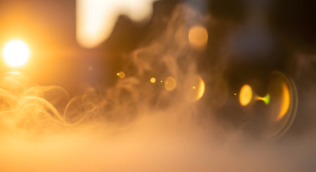 Abstract background with warm golden light, soft bokeh circles, and prominent lens flares creating a dreamy, atmospheric effect.の素材