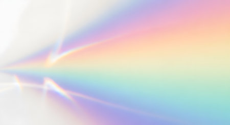 A soft, ethereal background featuring a gradient of pastel rainbow colors with subtle light flares and a blurred effect.の素材