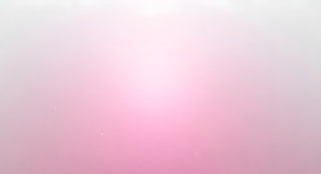 A gentle, abstract background featuring a smooth gradient transitioning from bright white at the top to soft pink at the bottom.の素材