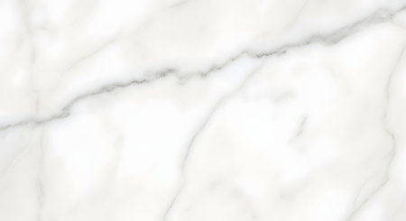 A close-up view of a white marble surface showcasing delicate gray veins and a smooth, polished finish.の素材